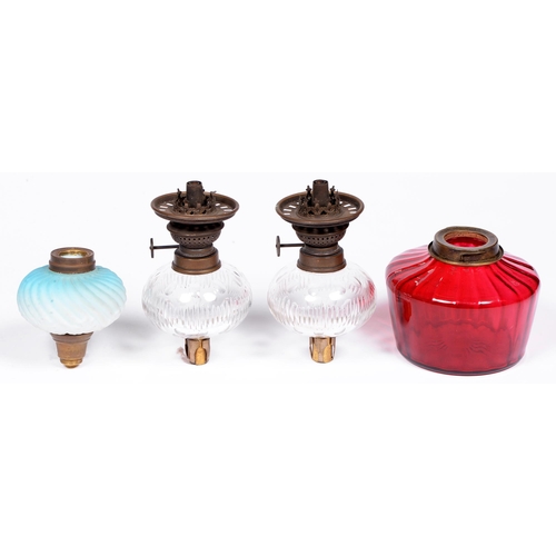 952 - A pair of Victorian peg lamps, with cut glass fount and brass burner, 17cm h, a cranberry glass lamp... 