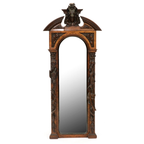 1141 - A German walnut and carved and stained wood mirror, late 19th c, the open segmental pediment centred... 