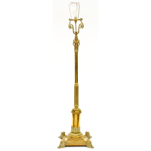 1174 - An Edwardian telescopic brass columnar oil lamp, on square base and four demi-lion feet, adapted for... 