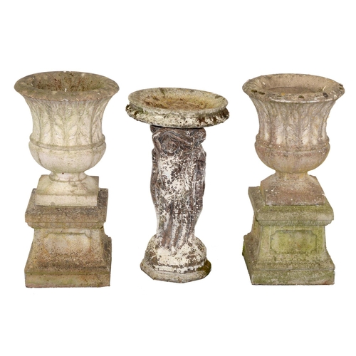 1175 - A pair of reconstituted stone garden vases and a bird bath, the vases of waisted spool shape decorat... 