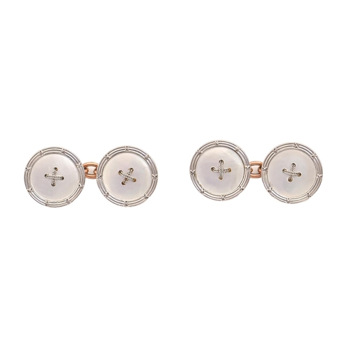 135 - A pair of white gold and mother of pearl 'stitch' cufflinks, early 20th c, backed in gold, 14mm diam... 