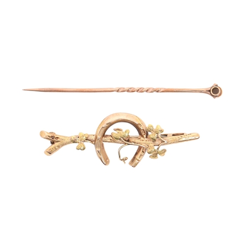 154 - A gold horseshoe twig brooch, early 20th c, 46mm l, marked 15ct, 2.3g and a gold stickpin, lacks ter... 