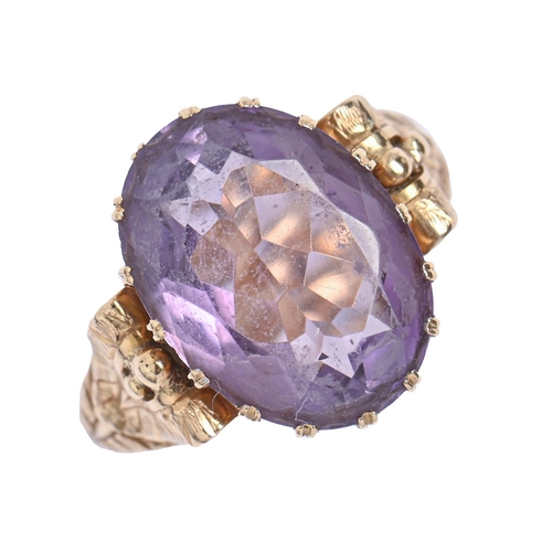 3 - A Continental amethyst ring, in gold, with chased hoop and leaf shoulders, indistinct maker's mark, ... 