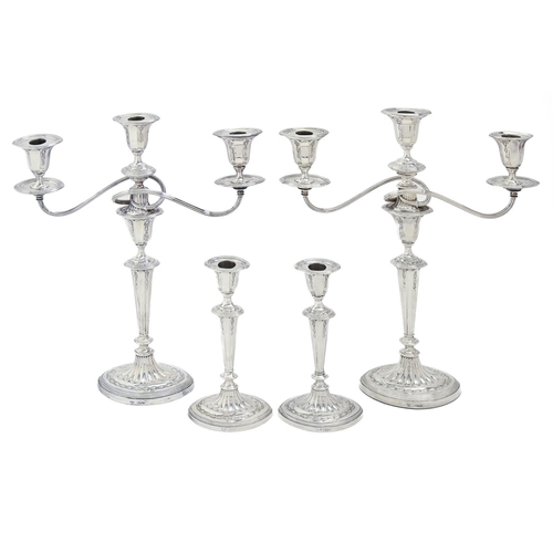 403 - A pair of Edwardian silver candelabra and a pair of candlesticks en suite, in Neo Classical style, o... 