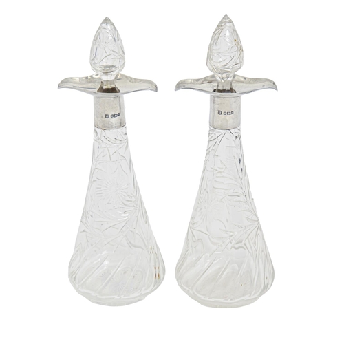 411 - A pair of Victorian double lipped silver mounted cut glass decanters and stoppers, 24cm h, by James ... 