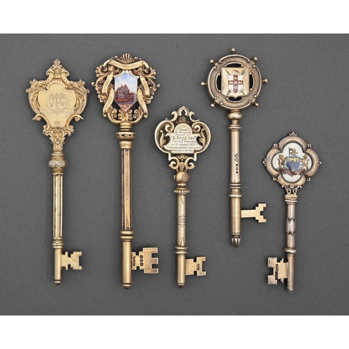 423 - Five Victorian, Edwardian and George V silver gilt ceremonial keys, four enamelled, variously inscri... 