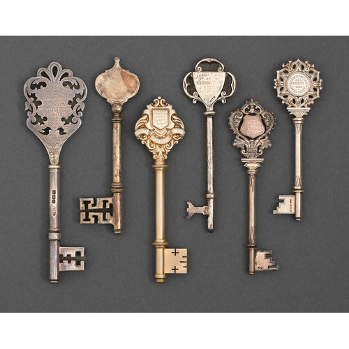 426 - Six Edwardian, George V and Elizabeth II silver and silver gilt ceremonial keys, one plain, the othe... 