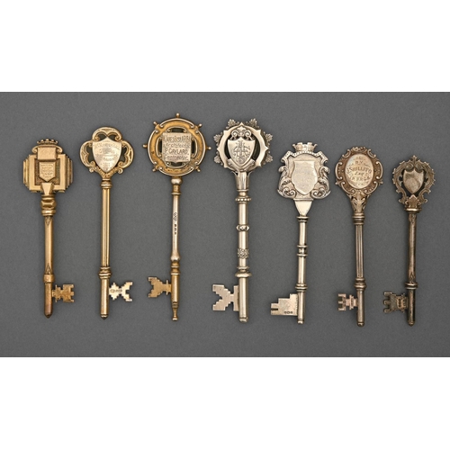 428 - Seven Edwardian and George V silver and silver gilt ceremonial keys, variously inscribed, 10.3-13cm ... 