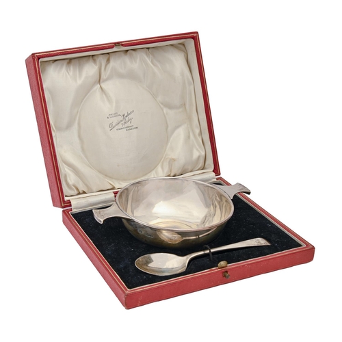 435 - A George V silver porringer and spoon, 16.5cm over handles, by Martin, Hall & Co Ltd, Sheffield ... 