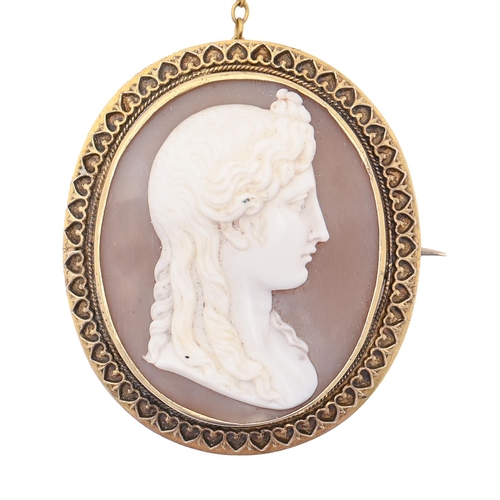 49A - A Victorian Etruscan revival cameo brooch, the oval shell carved with the head of a classical woman,... 