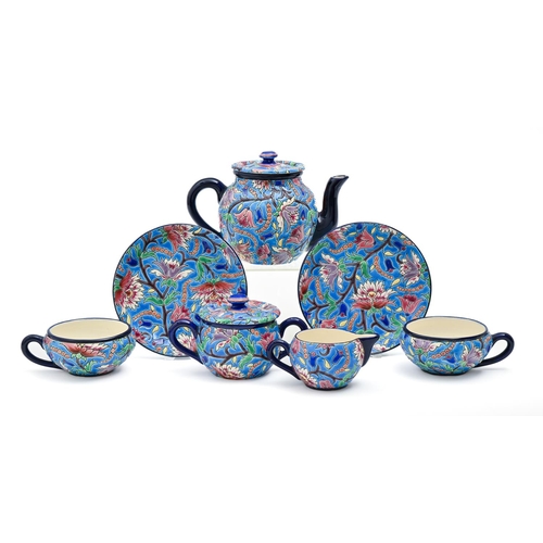 605 - A Longwy tea service, early 20th c, with brightly coloured 'cloisonne' flowers and foliage on a vivi... 