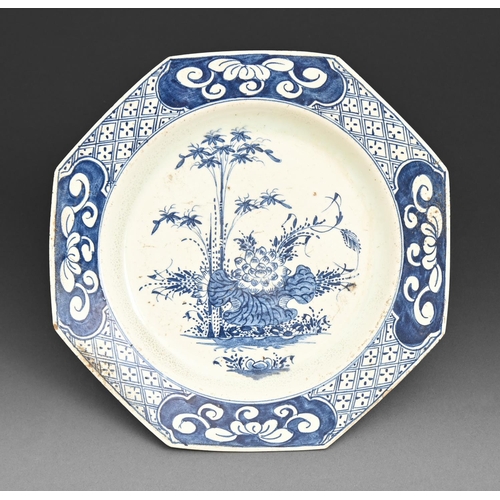 607 - An octagonal Bow blue and white plate, c1756-60, painted with a prominent flower and large leaf with... 