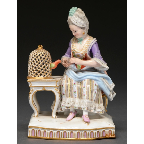 644 - A Meissen allegorical figure of a woman seated beside a caged bird, mid 19th c after the original mo... 