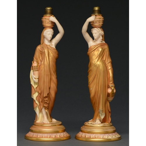 657 - A pair of Royal Worcester figures of Grecian water carriers, 1913, with contemporary brass fitm... 