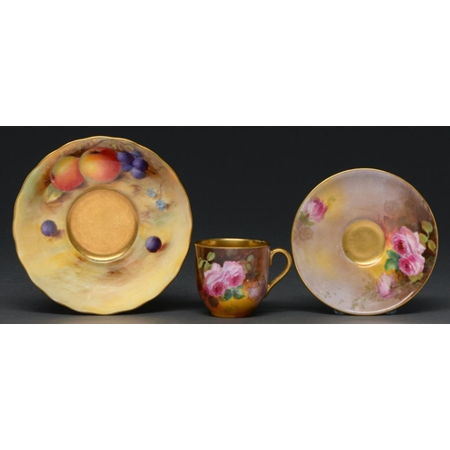 659 - A Royal Doulton coffee cup and saucer, c1930, painted by E Perry, both signed, with roses, saucer 95... 