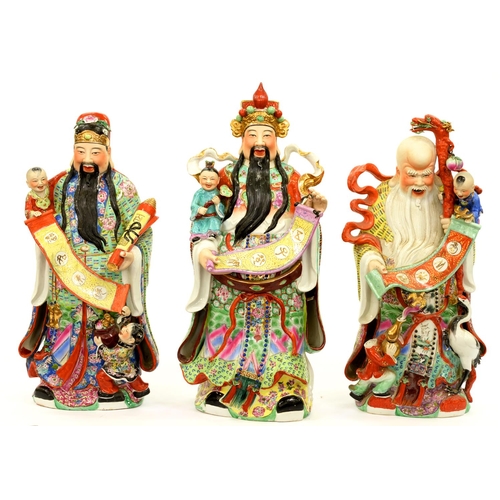 713 - A set of three unusually large South East Asian famille rose and painted biscuit figures of immortal... 