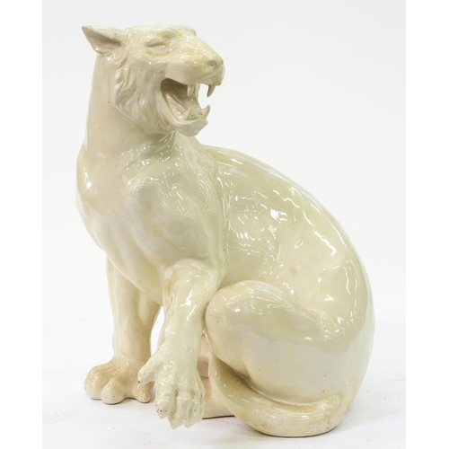 714 - A white glazed earthenware model of a tigress, late 20th c, 73cm h