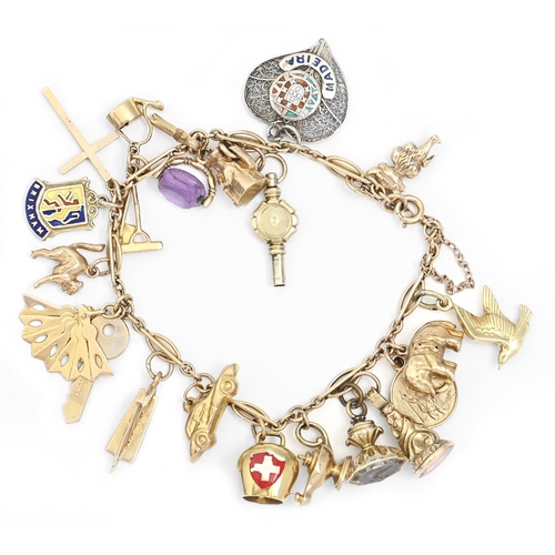 87 - A gold charm bracelet, the charms including lyre, kettle, amethyst swivel, toby jug and watch key an... 