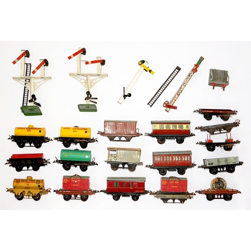 893 - A collection of Hornby O gauge wagons, tankers and other rolling stock and signals