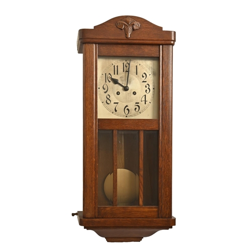 920 - An oak wall clock, 1930s, silvered dial and bevelled glass lights, pendulum, 77cm h and an oak mante... 