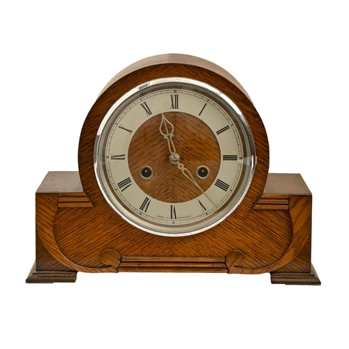 920 - An oak wall clock, 1930s, silvered dial and bevelled glass lights, pendulum, 77cm h and an oak mante... 