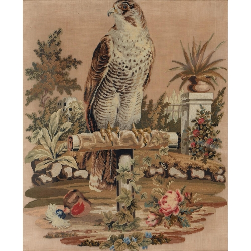 928 - A Victorian Berlin woolwork picture of  falcon on a perch in a garden with glass eye, 67 x 55cm... 