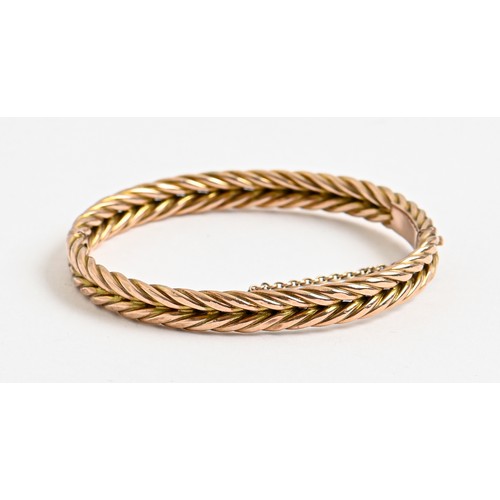 174 - A gold bangle, c1900, of rigid woven design, 56mm (internal), 10.5g