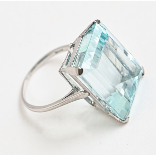 187 - An aquamarine ring, the step cut aquamarine 17 x 22mm, in white gold marked 18ct, 11.2g, size R... 