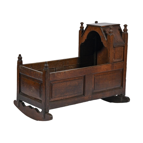 1188 - A joined oak cradle, North England, first half 18th c, with six turned finials, the sides of six rai... 