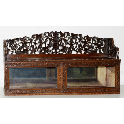 1209 - An Anglo Indian blackwood cabinet, late 19th c, with carved and pierced gallery of fruit and foliage... 