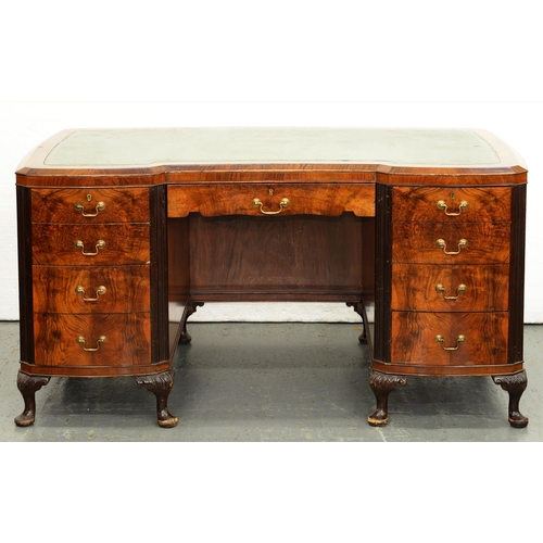 1222 - A walnut desk, second quarter 20th c, with gilt tooled blue leather inset writing surface and fitted... 