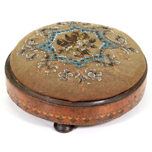 1229 - A Victorian walnut and inlaid footstool with beadwork top, 27cm diam