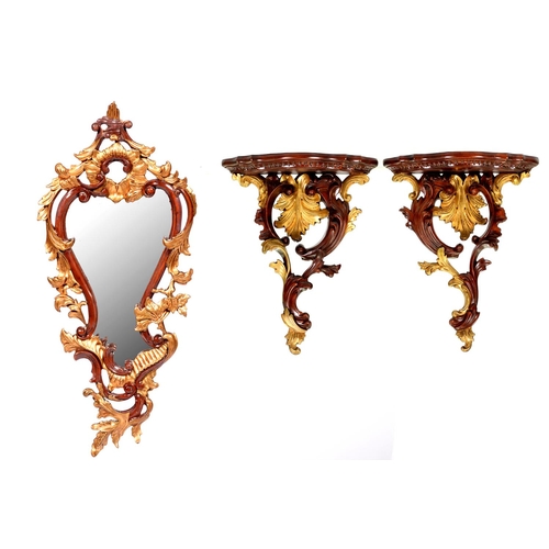 1237 - A pair of mahogany-stained and gilt carved wood wall brackets and a mirror, late 20th c, in Rococo s... 