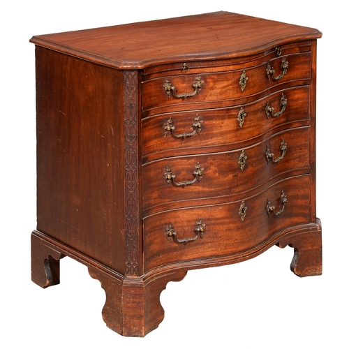 1324 - A George III serpentine mahogany chest of drawers, the top with moulded lip and angles above brushin... 