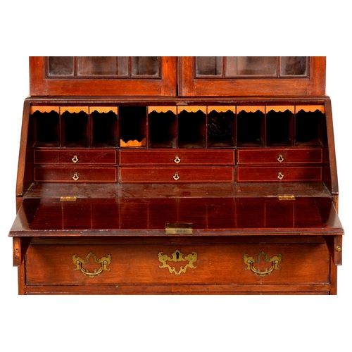 1338 - A George III mahogany bureau, the associated bookcase with dentil cornice above adjustable shelves e... 