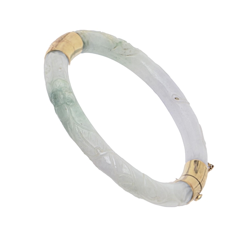 146 - A gold mounted Chinese carved jadeite bangle, 20th c, with engraved mounts, 60mm (internal), marked ... 