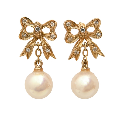 169 - A pair of cultured pearl and diamond bow shaped earrings, in gold, 19mm, 2.3g