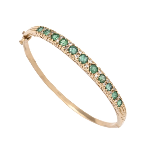 59 - An emerald and diamond bangle, in 9ct gold, 56mm (internal), London 1989, 12.8g