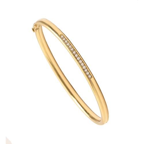 62 - A diamond bangle, in gold, 60mm (internal), control marks and 750, 22.3g