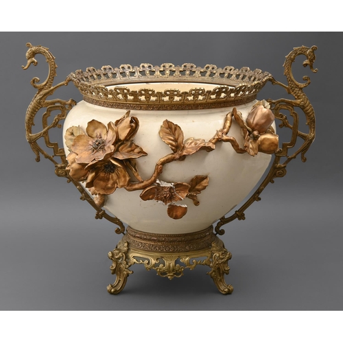 882 - A French brass mounted cream earthenware jardiniere, c1890 with dragon handles and applied with bron... 