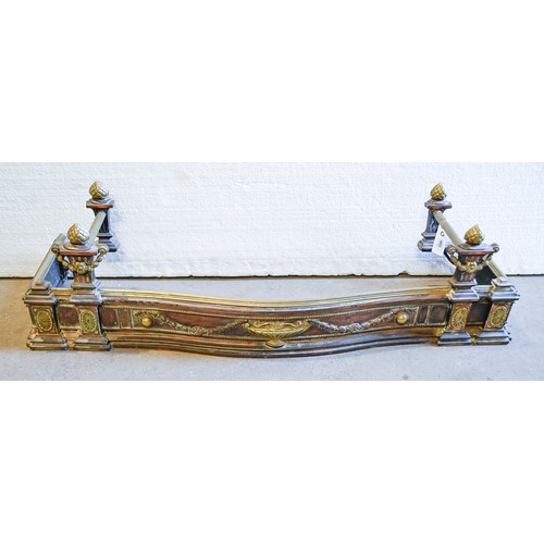 1396 - An Edwardian serpentine brass and oxidised art metal fender, with neo classical urn, paterae and fes... 