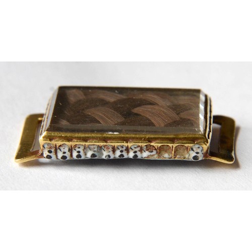 137 - An English gold and enamel memento mori slide, early 18th c, inset with plaited hair, the reverse pa... 