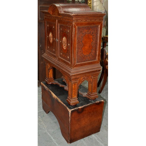 1212 - A Spanish tooled leather writing cabinet, c1920, with breakarched pediment and fitted interior with ... 