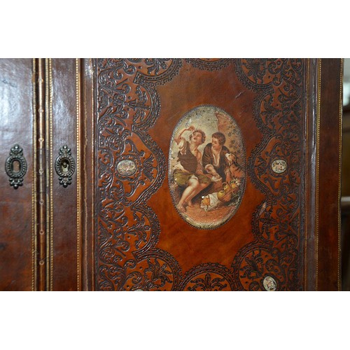 1212 - A Spanish tooled leather writing cabinet, c1920, with breakarched pediment and fitted interior with ... 