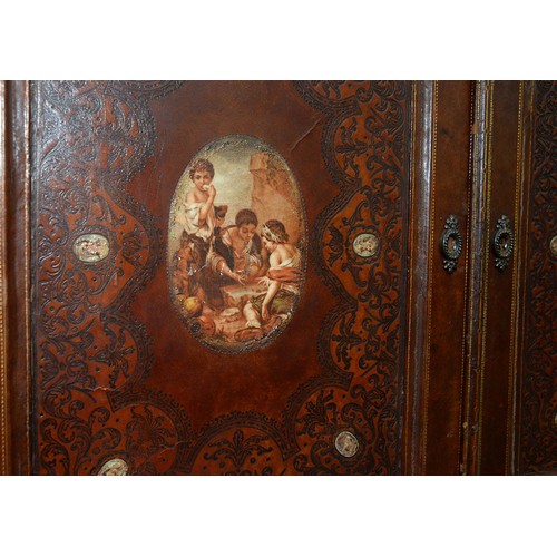 1212 - A Spanish tooled leather writing cabinet, c1920, with breakarched pediment and fitted interior with ... 