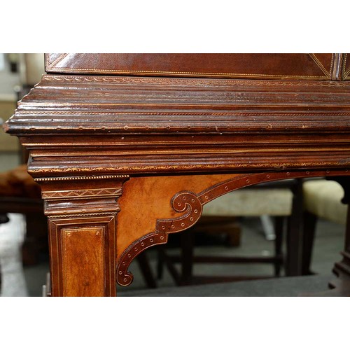 1212 - A Spanish tooled leather writing cabinet, c1920, with breakarched pediment and fitted interior with ... 