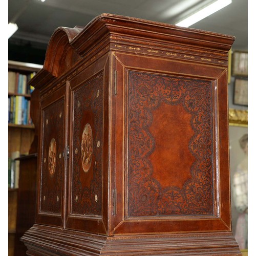 1212 - A Spanish tooled leather writing cabinet, c1920, with breakarched pediment and fitted interior with ... 