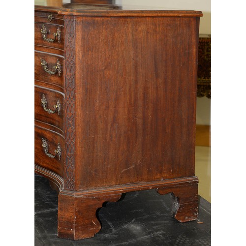 1324 - A George III serpentine mahogany chest of drawers, the top with moulded lip and angles above brushin... 