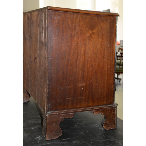 1324 - A George III serpentine mahogany chest of drawers, the top with moulded lip and angles above brushin... 