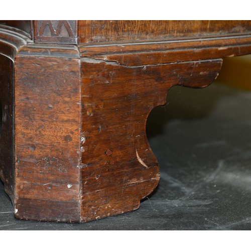 1324 - A George III serpentine mahogany chest of drawers, the top with moulded lip and angles above brushin... 